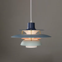 Blue layered pendant light with softly illuminated stacked shades and a modern sculptural silhouette.