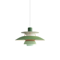 Green layered pendant light displayed against a plain background with a soft modern color palette.
